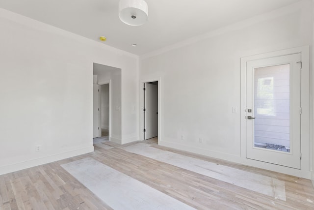 empty room with light hardwood / wood-style flooring