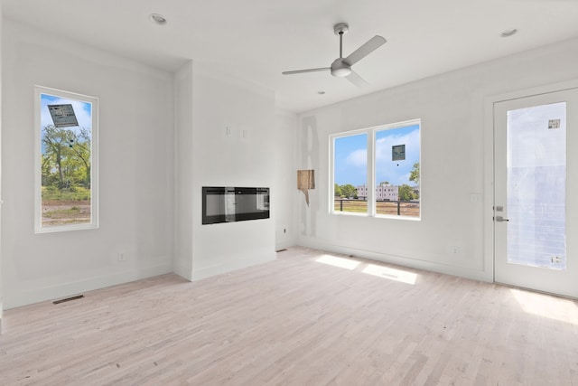 unfurnished living room with light hardwood / wood-style floors and ceiling fan