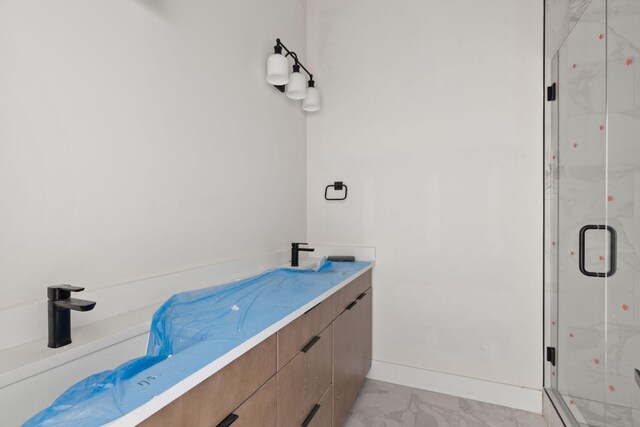 1016 W Trinity Ln Unit 15, Nashville, TN 37218 - bathroom with a marble finish shower, marble look tile flooring, and vanity