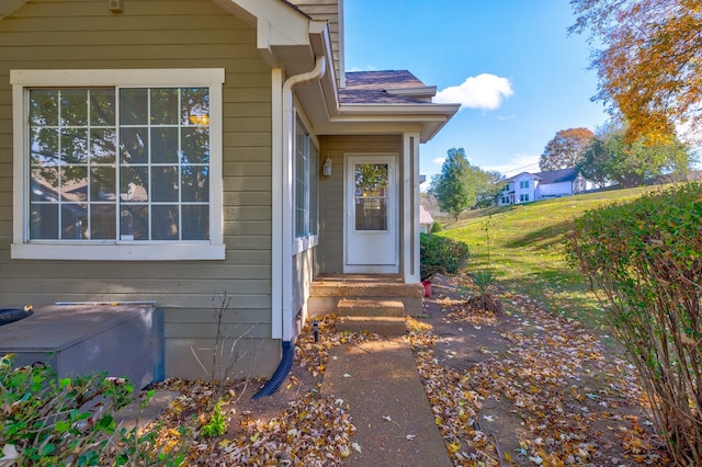 doorway to property featuring a yard