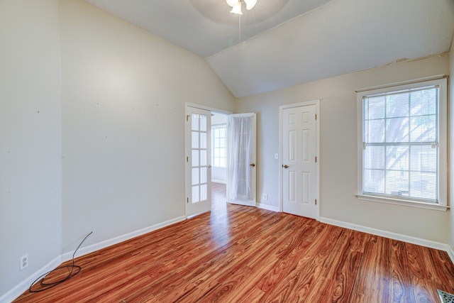 spare room featuring light hardwood / wood-style flooring, ceiling fan, and vaulted ceiling