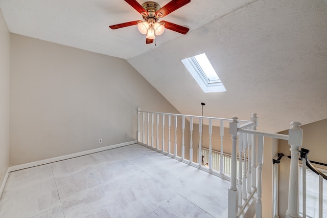 additional living space featuring ceiling fan, plenty of natural light, and lofted ceiling