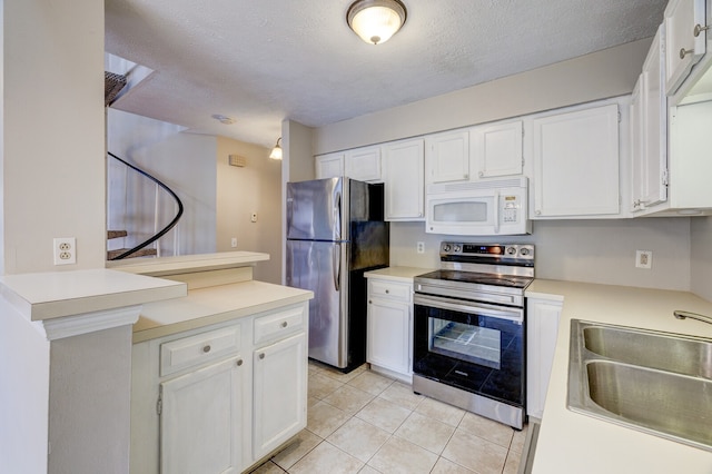 kitchen featuring light tile patterned flooring, appliances with stainless steel finishes, a textured ceiling, sink, and white cabinets