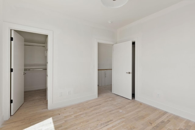 1016 W Trinity Ln Unit 18, Nashville, TN 37218 - unfurnished bedroom with wood finished floors, a walk in closet, and baseboards