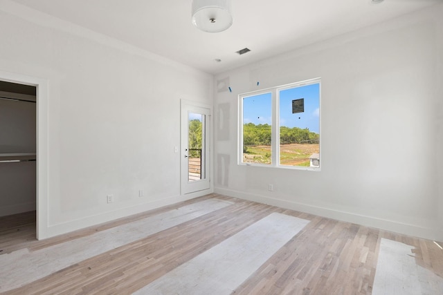 1016 W Trinity Ln Unit 18, Nashville, TN 37218 - unfurnished bedroom with baseboards, light wood-style floors, access to exterior, and a walk in closet