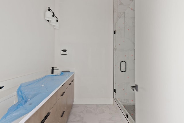 1016 W Trinity Ln Unit 18, Nashville, TN 37218 - full bath with marble look tile flooring, a marble finish shower, and vanity