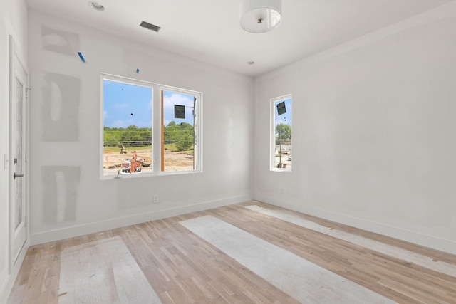 1016 W Trinity Ln Unit 18, Nashville, TN 37218 - unfurnished room featuring plenty of natural light, baseboards, and light wood-style flooring