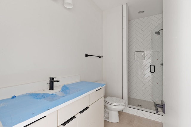 bathroom with tile patterned flooring, an enclosed shower, vanity, and toilet