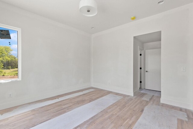 1016 W Trinity Ln Unit 19, Nashville, TN 37218 - empty room with light wood-style floors, baseboards, and a smoke detector