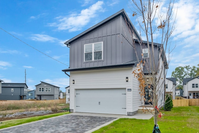 view of front of home with a garage and a front lawn