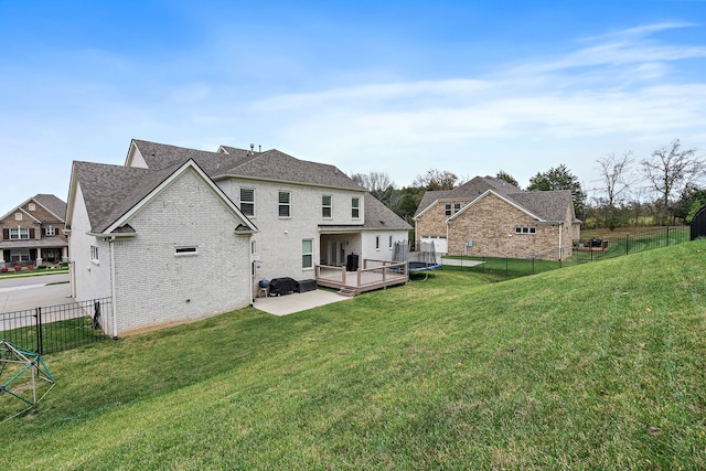 rear view of property with a yard and a deck