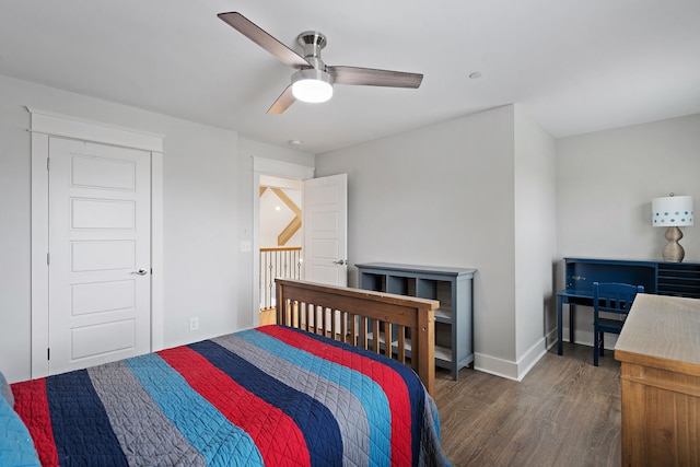 bedroom with dark hardwood / wood-style flooring and ceiling fan