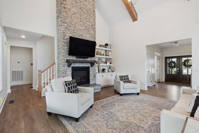 living room with french doors, dark wood-type flooring, high vaulted ceiling, beam ceiling, and a fireplace