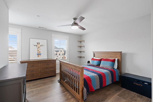 bedroom with dark wood-type flooring and ceiling fan