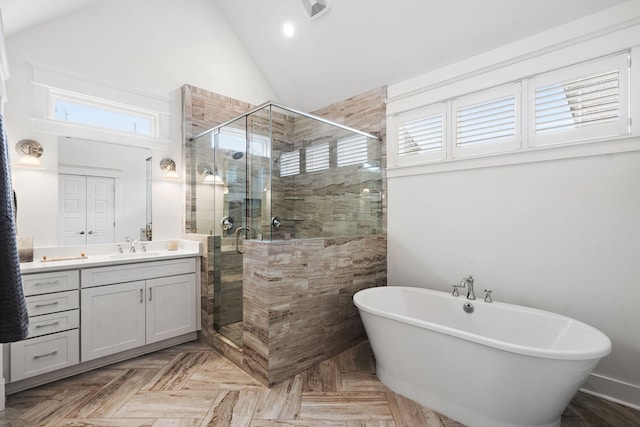 bathroom featuring high vaulted ceiling, vanity, and shower with separate bathtub