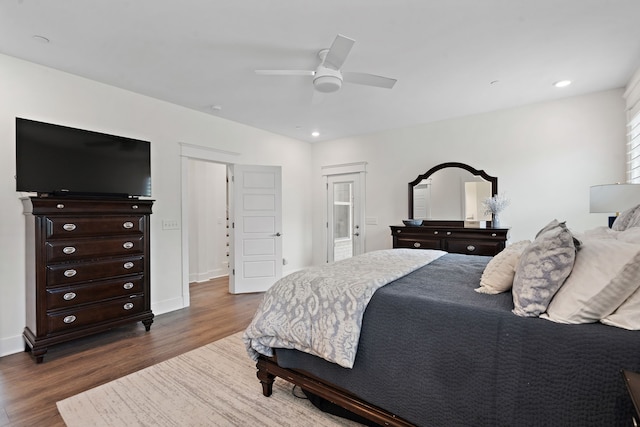 bedroom with ceiling fan and dark hardwood / wood-style floors