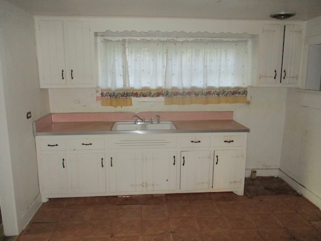 kitchen featuring white cabinets, a healthy amount of sunlight, and sink