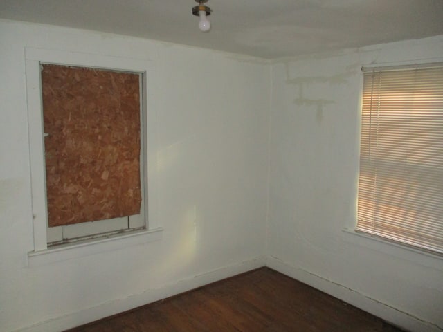 unfurnished room featuring dark hardwood / wood-style floors