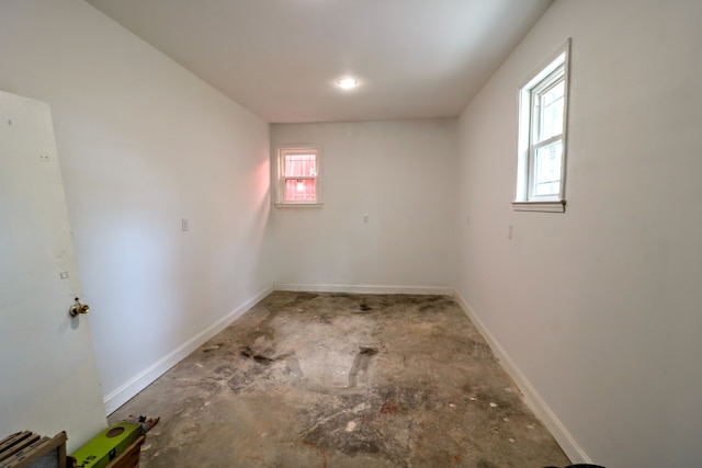 unfurnished room with concrete floors