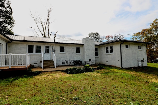 rear view of property with a lawn