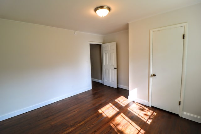 unfurnished bedroom featuring dark hardwood / wood-style flooring