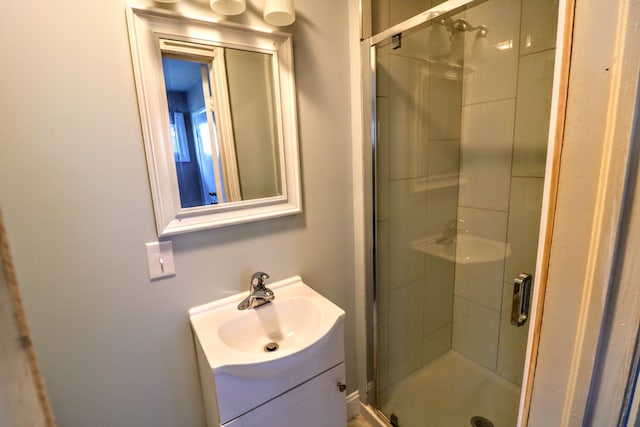 bathroom with vanity and a shower with door