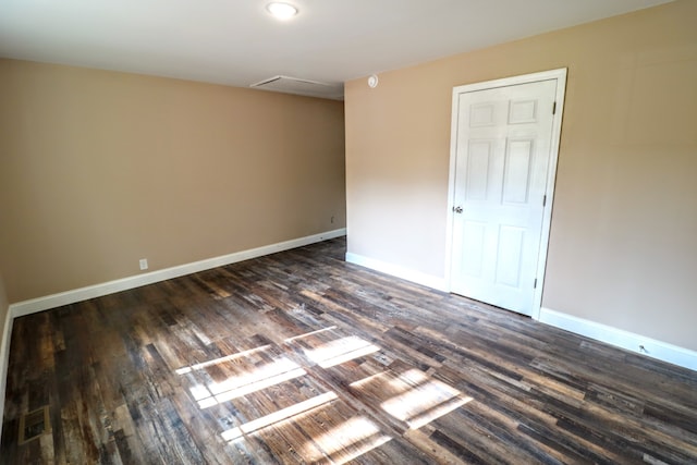 empty room featuring dark wood-type flooring