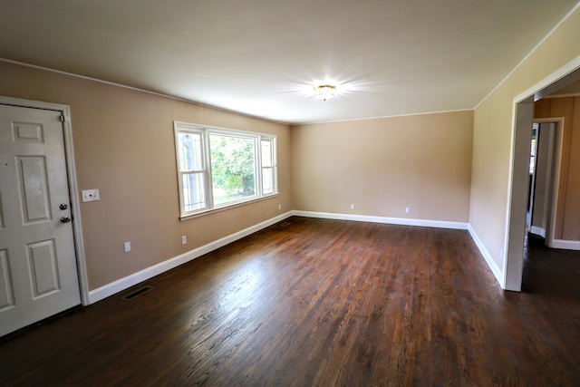 empty room featuring dark hardwood / wood-style flooring