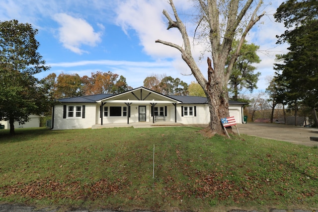 ranch-style house with a porch, a garage, and a front yard