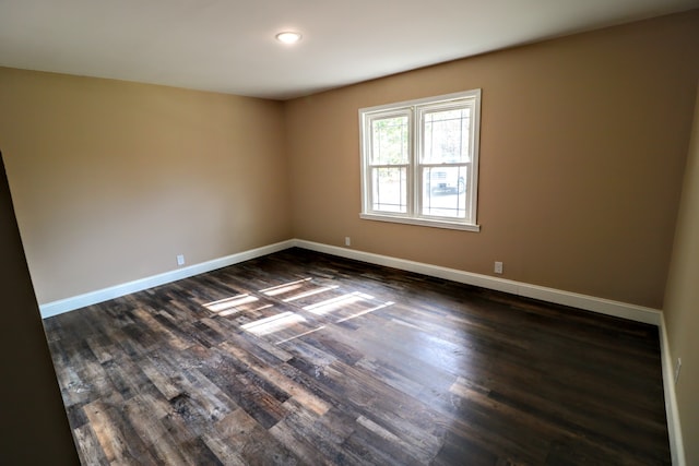 unfurnished room featuring dark wood-type flooring