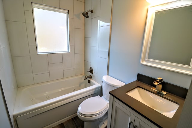 full bathroom with vanity, toilet, and tiled shower / bath