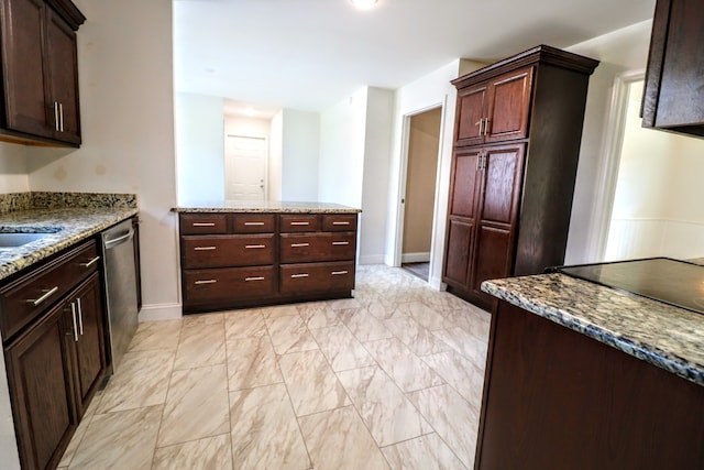 kitchen with sink, light stone countertops, and dishwasher