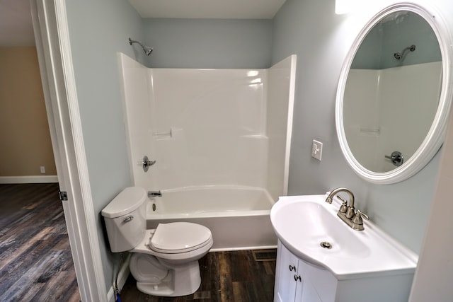 full bathroom with vanity, hardwood / wood-style flooring, shower / washtub combination, and toilet