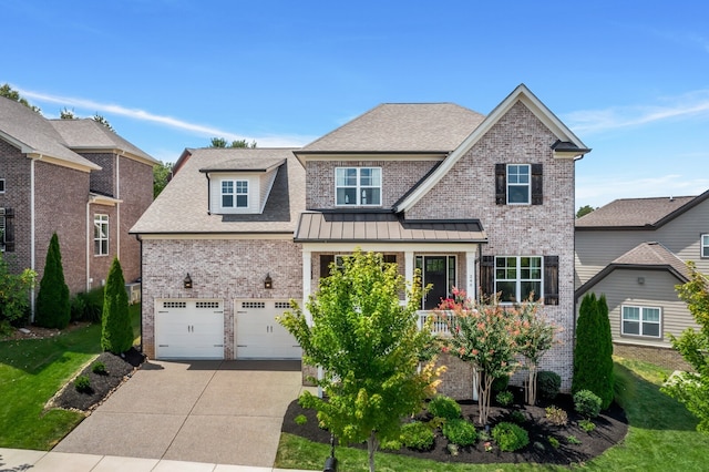 craftsman-style house featuring a garage, a front yard, and covered porch