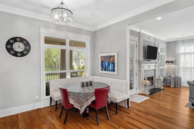 dining area featuring a wealth of natural light, wood-type flooring, and a notable chandelier