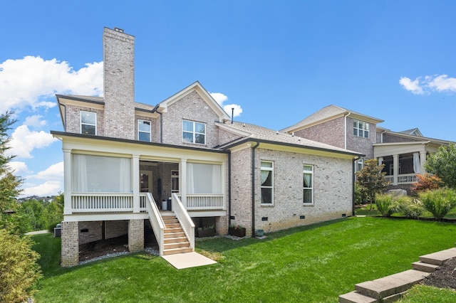 back of property with a sunroom and a yard