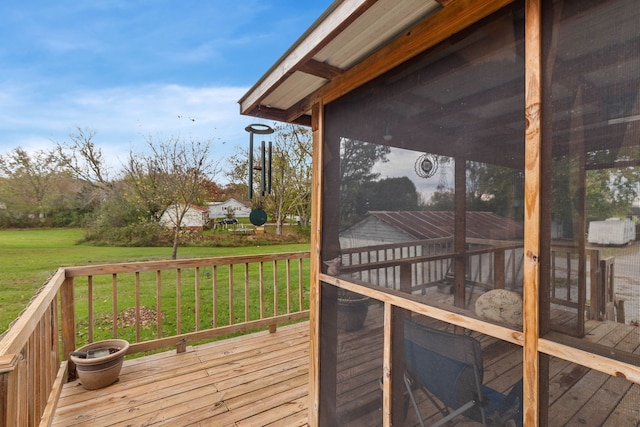 wooden terrace with a yard and a sunroom