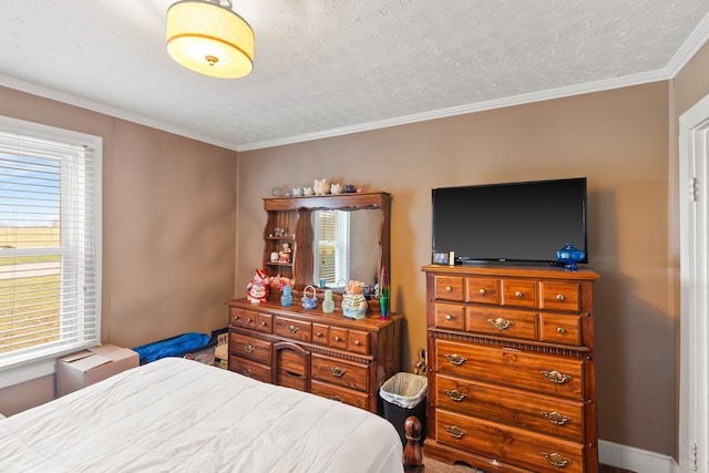 bedroom with multiple windows, a textured ceiling, and ornamental molding