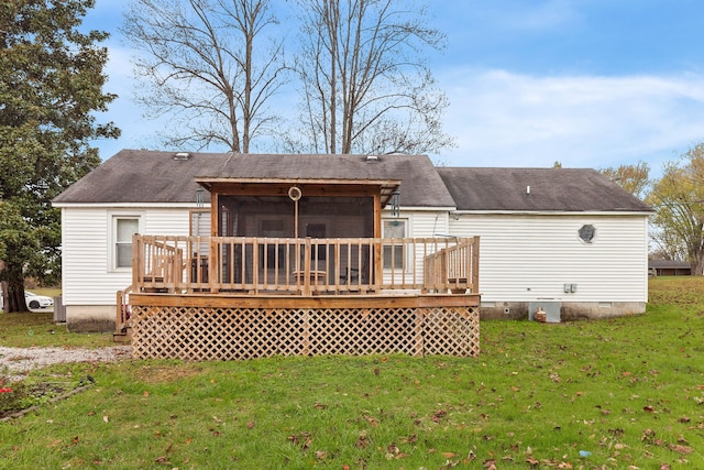 rear view of property featuring a sunroom, a yard, and a deck