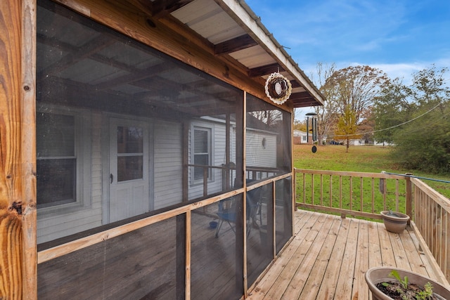 deck featuring a lawn and a sunroom