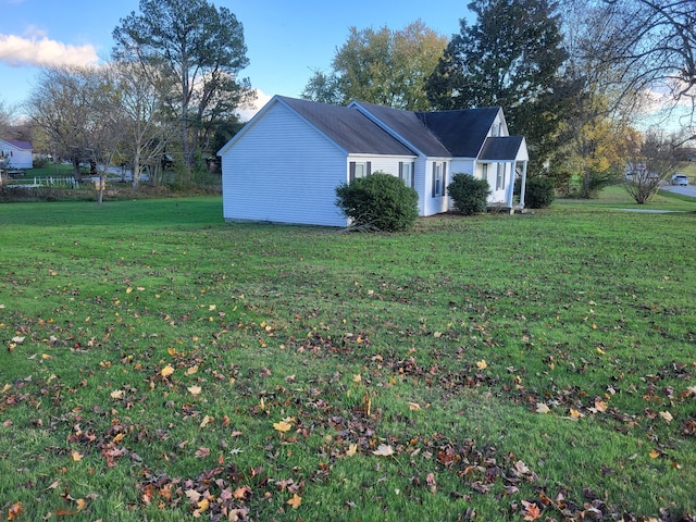 view of property exterior with a lawn