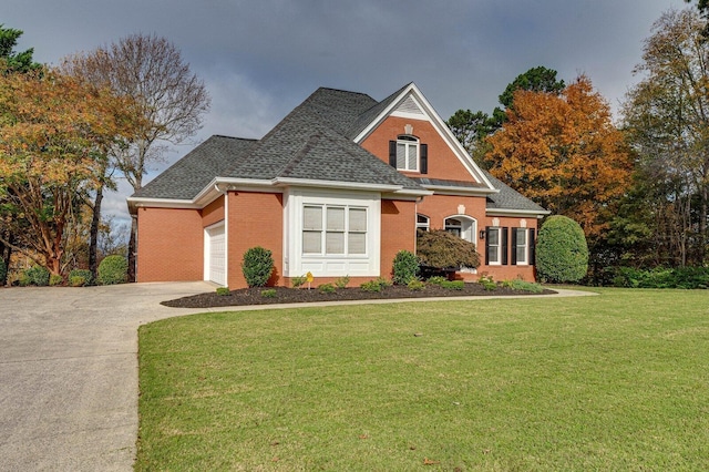 view of property featuring a garage and a front yard