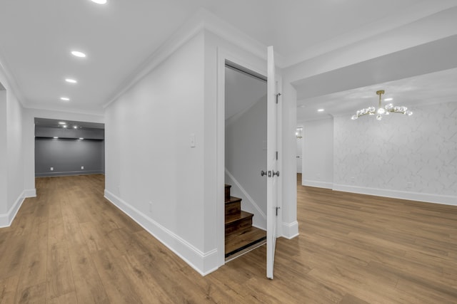 corridor with hardwood / wood-style flooring and crown molding