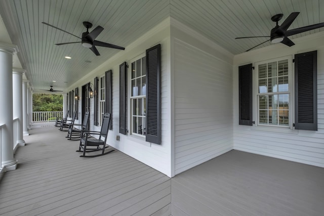 wooden terrace featuring a porch and ceiling fan