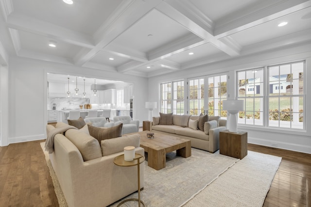 living room featuring light hardwood / wood-style flooring, beamed ceiling, and plenty of natural light