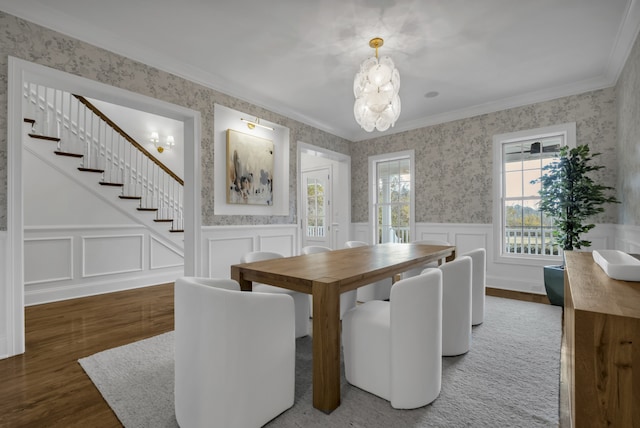 dining room with dark wood-type flooring, a chandelier, and ornamental molding