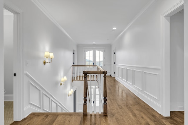 hallway with hardwood / wood-style flooring and crown molding