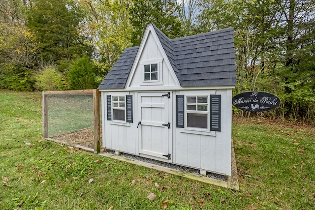 view of outbuilding with a yard