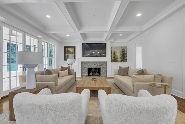 living room featuring hardwood / wood-style floors, coffered ceiling, beamed ceiling, crown molding, and a fireplace