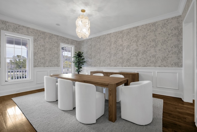 dining area with dark hardwood / wood-style flooring, a notable chandelier, and crown molding